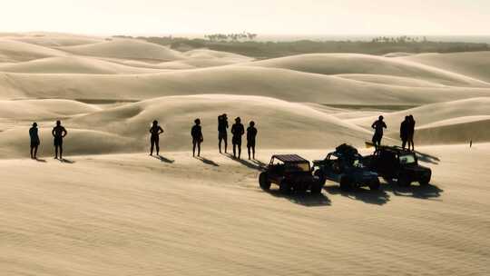 一群人开车来沙丘上