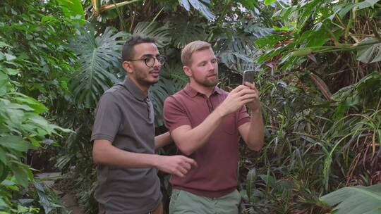男子在植物园用智能手机拍摄