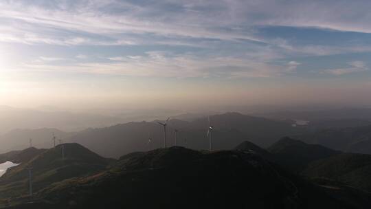 航拍夕阳下山顶风力发电机