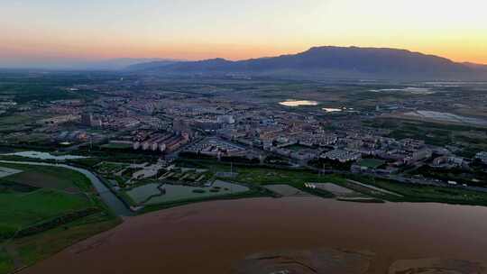 航拍夕阳下宁夏石嘴山惠农区城市风光