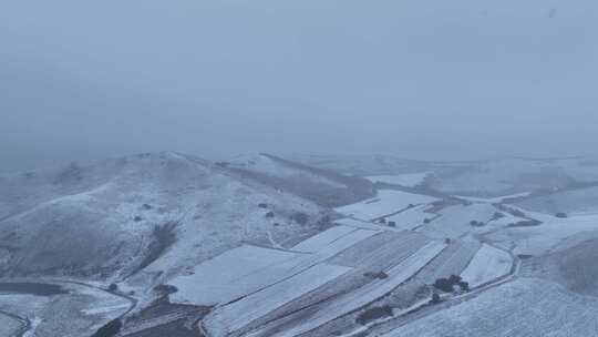 航拍风雪交加的山脉田野