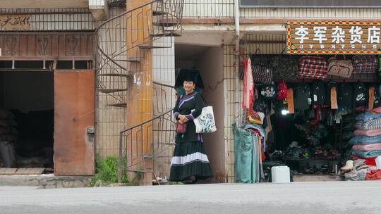 民族视频云南丽江小镇路旁等车彝族妇女