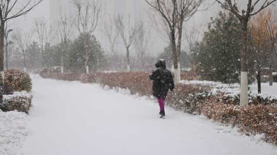 大雪纷飞中孤独行走的人背影