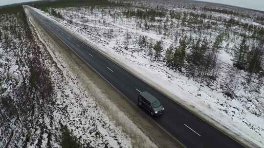 货车在被雪包围的笔直道路上行驶