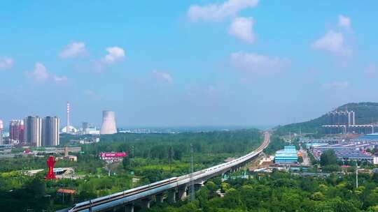 航拍枣庄高速高铁入口的蓝天白云森林城市