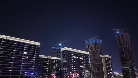 仰视夜景城市楼盘房地产开发建设上升俯瞰