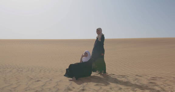 在多风的沙漠中摆姿势的女人