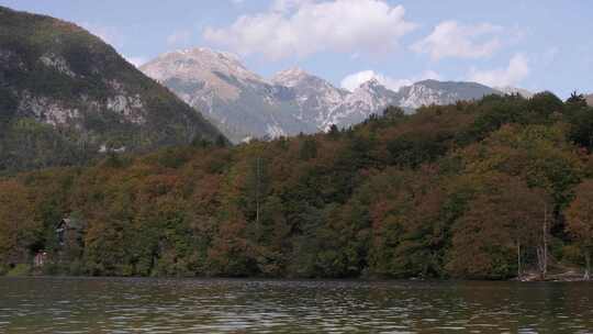太阳出现在Bohinj湖的秋天色彩上，展示了阿尔卑斯山令人惊叹的色彩