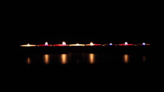一群一组燃烧殆尽的蜡烛散发微微的烛光光满