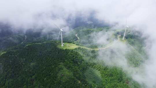 航拍高山青山云雾风车风力发电