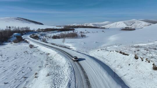 追拍山区冰雪道路上行驶的汽车