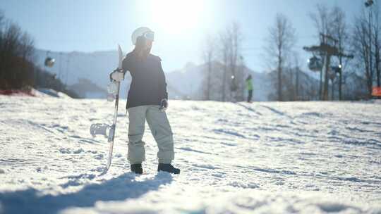 冬季运动和娱乐妇女在滑雪板设备站在斜坡上