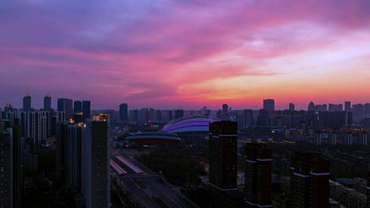 城市落日晚霞日转夜灯光沈阳五里河体育场视频素材模板下载