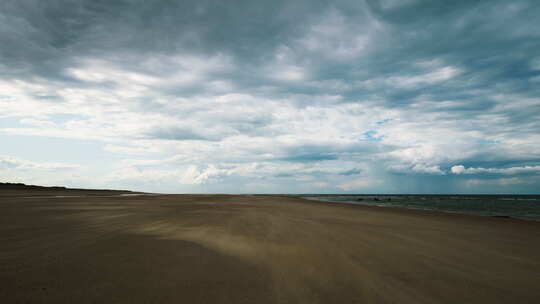 沙子吹过荒凉的海滩，上面有移动的云视频素材模板下载