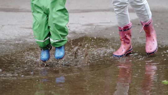 穿着雨靴的孩子在公园玩耍