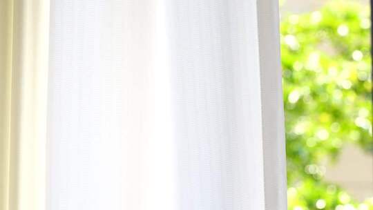 风吹窗帘窗户白色窗帘飘动阳光透过白色窗帘