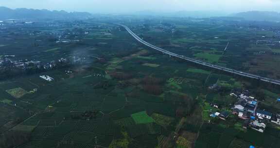 航拍四川雨天高速公路穿越农田茶园