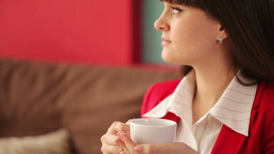 女人坐在咖啡馆里喝着咖啡视频素材模板下载