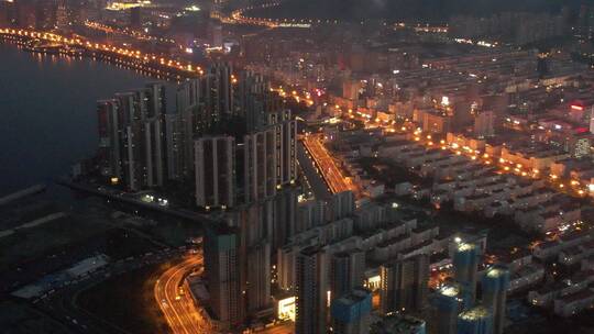 航拍威海湾九里的城市夜晚灯火街道海岸