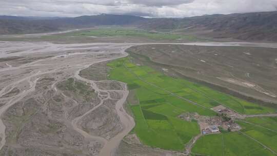 航拍西藏藏区湿地中的农田田地