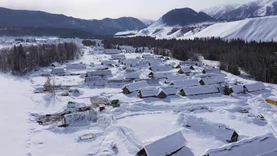 航拍新疆禾木雪景森林雪地小木屋禾木桥雪山