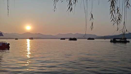 湖面落日游船垂柳风景