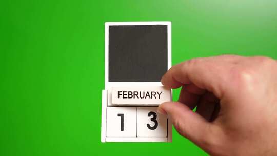 02.绿色背景上日期为2月13日的日历。视频素材模板下载