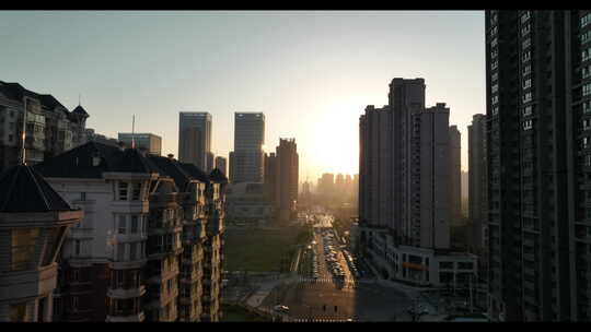 城市空境航拍大楼早晨光日出建筑居民楼太阳