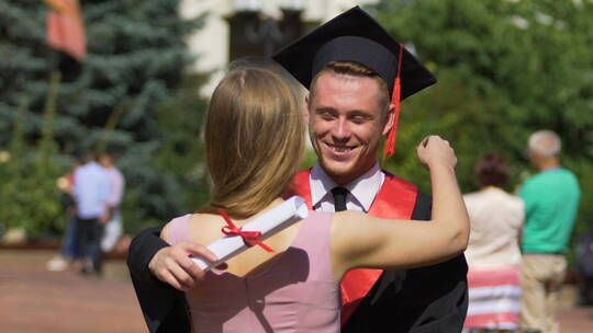 女人祝贺男朋友毕业后拥抱