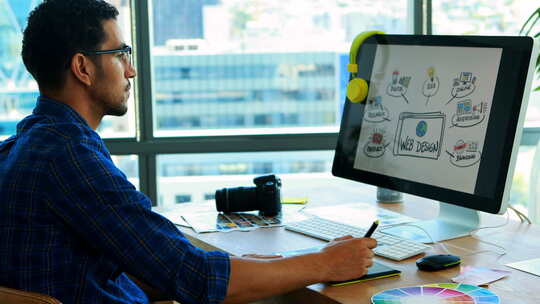 男性平面设计师在办公桌上用平板电脑工作