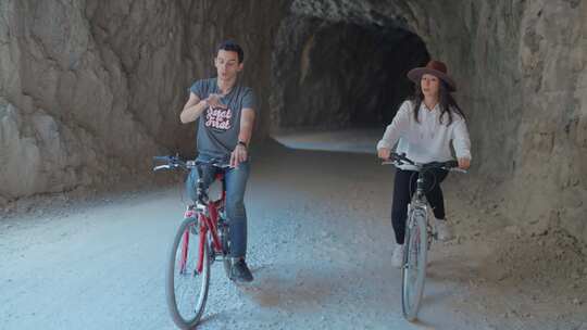 旅游情侣在石路上骑单车