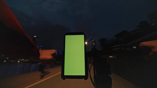 赛车手带着绿屏手机在夜骑