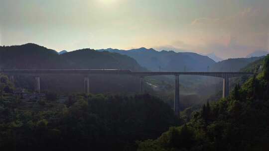 日落时分火车行驶在高架桥上