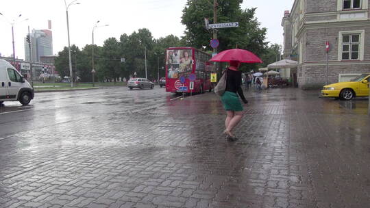 塔林爱沙尼亚雨中撑伞的行人视频素材模板下载