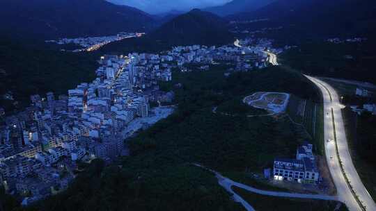航拍广东茂名信宜钱排镇群山环绕的城镇夜景
