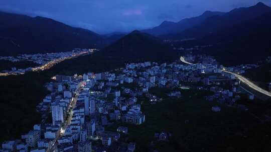 航拍广东茂名信宜钱排镇群山环绕的城镇夜景