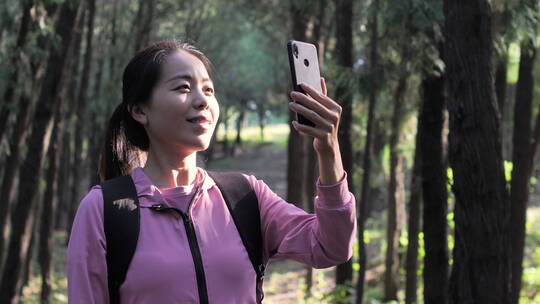 亚洲中国人女性森林树林旅游拿望远镜看风景