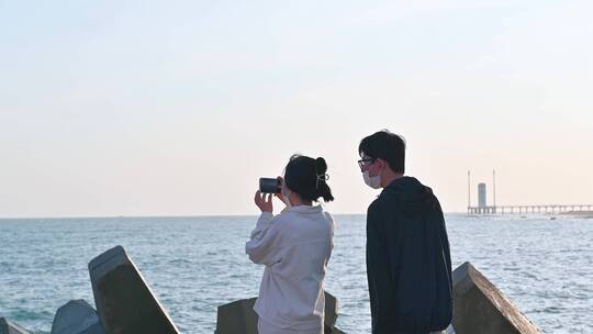 在三亚海边等待拍摄日出的游客