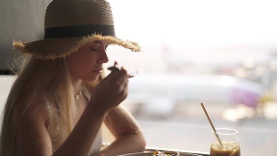 女人在机场窗口吃饭