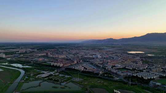 航拍夕阳下宁夏石嘴山惠农区城市风光