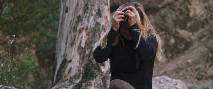 女人在河边用河水洗脸