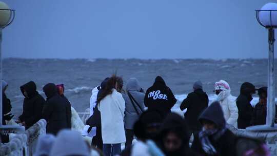 山东威海金海湾栈桥的冰海游客大浪狂风