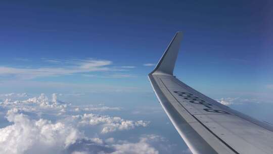 航空飞机在云层之上窗外蓝天白云视频素材模板下载
