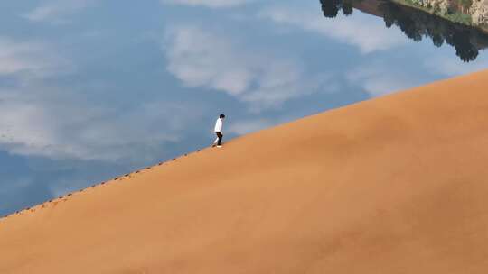 航拍沙漠沙脊上行走的人