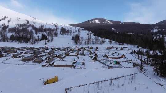 航拍新疆冬季喀纳斯湖雪景森林雪山下的村落