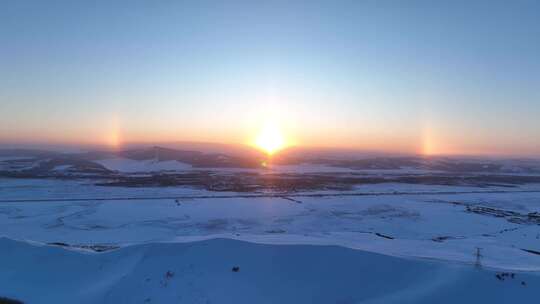 航拍寒冬雪域雪原灿烂夕阳