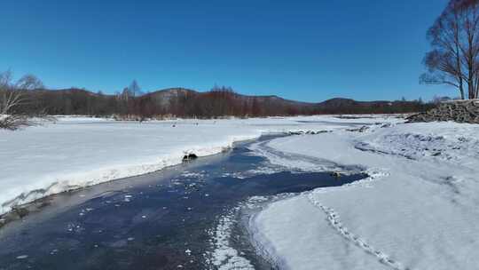 航拍初春库都尔河开河雪景