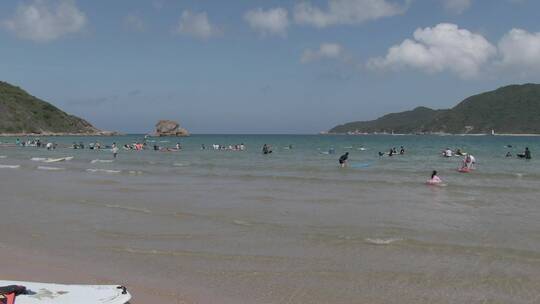航拍海南三亚后海海滩冲浪游玩视频素材模板下载