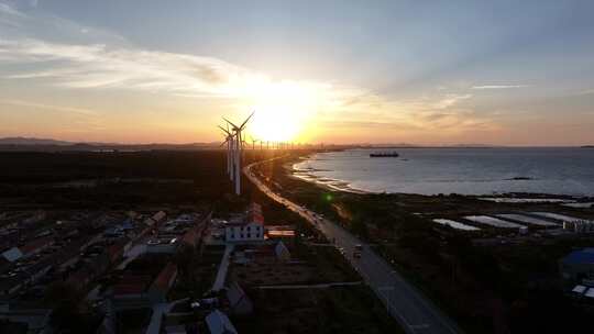 航拍山东荣成环海路风力发电机群晚霞落日