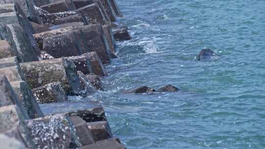 海浪拍打海边防护堤坝